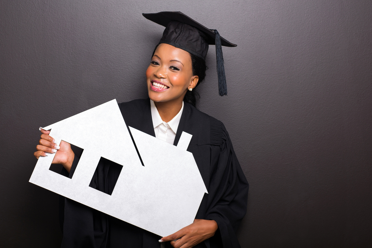 attractive african female university graduate holding white paper house